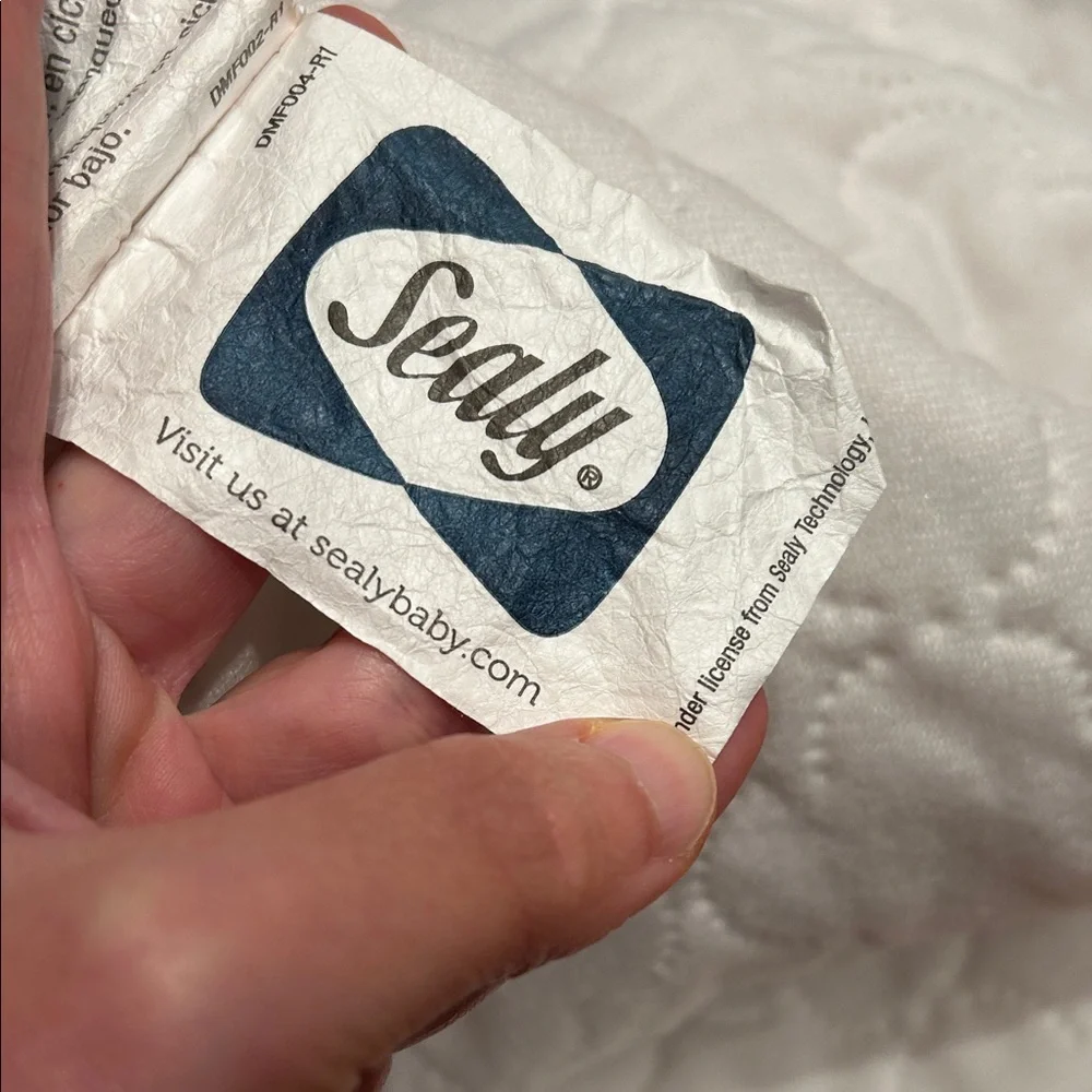 Two Sealy Crib Mattress Protectors